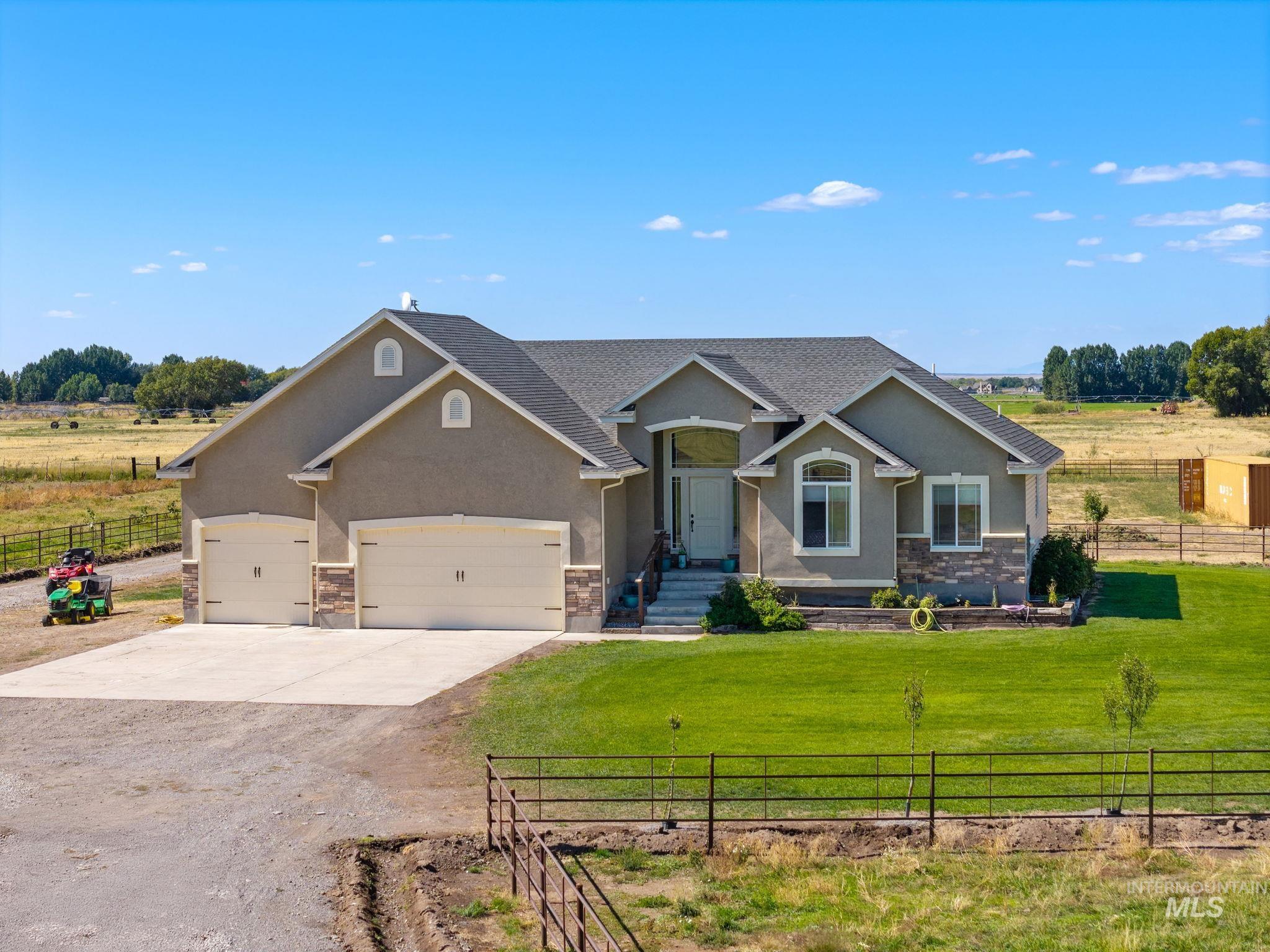3625 North 2000 West Rexburg, ID 83440 - Photo 31 of 50 Craftsman inspired home featuring concrete driveway, stucco siding, a rural view, and stone siding
