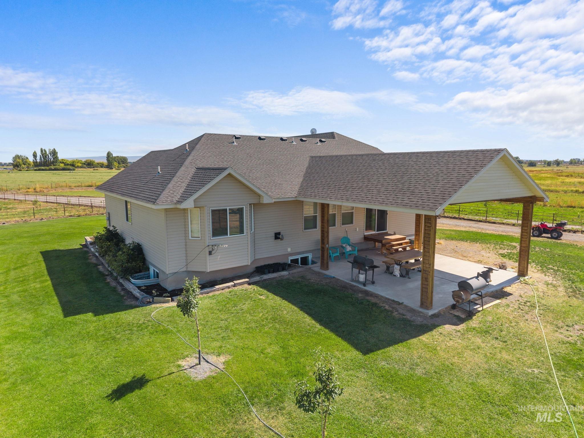 3625 North 2000 West Rexburg, ID 83440 - Photo 34 of 50 Rear view of property with roof with shingles, a patio area, and a rural view