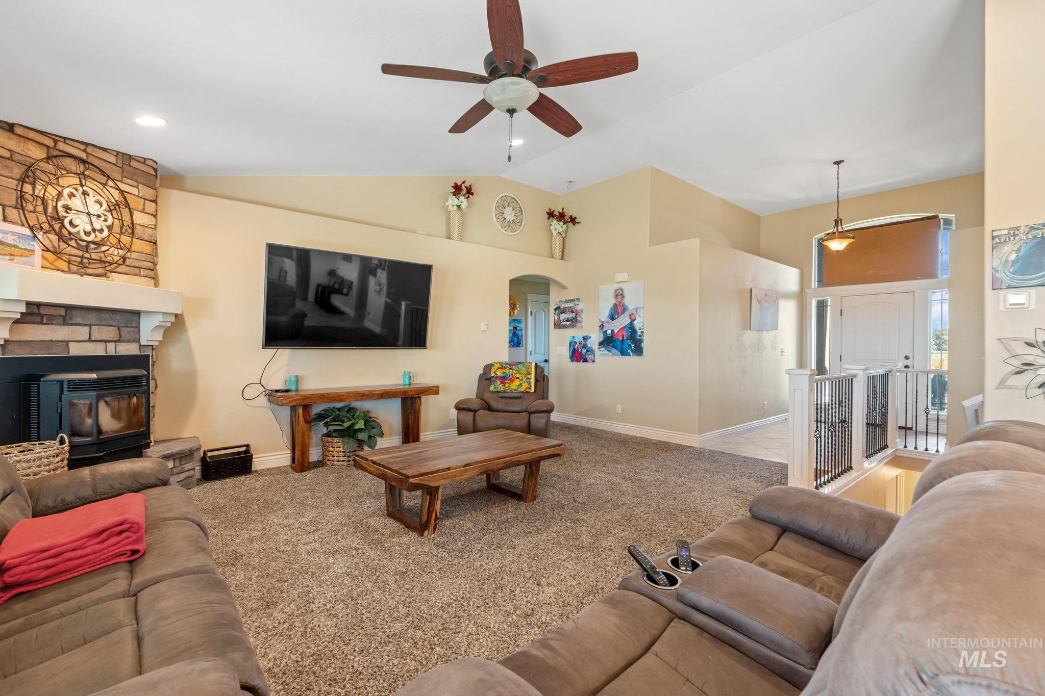 3625 North 2000 West Rexburg, ID 83440 - Photo 50 of 50 Living area with light carpet, arched walkways, ceiling fan, and high vaulted ceiling