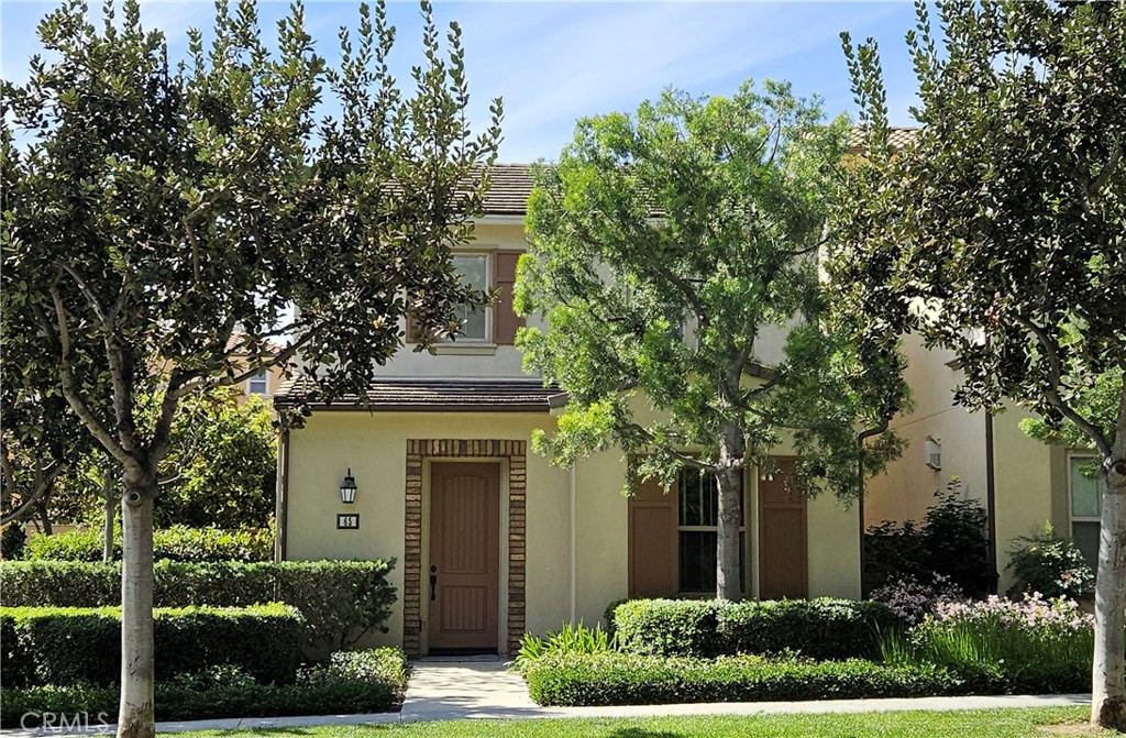front view of a house with a tree
