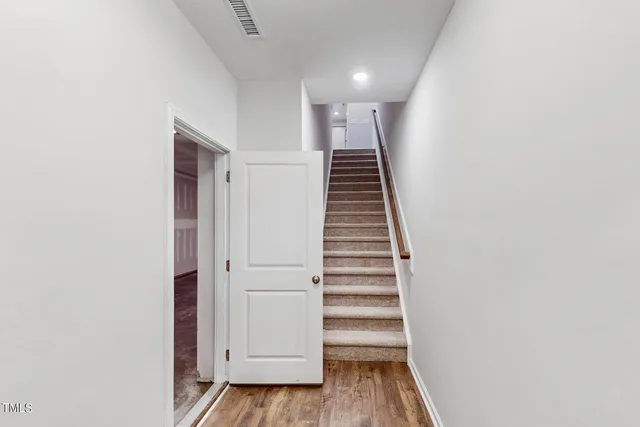 a view of a hallway with wooden floor