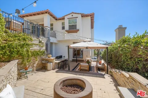 a backyard of a house with table and chairs