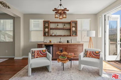 a view of a dining room with furniture a chandelier and wooden floor