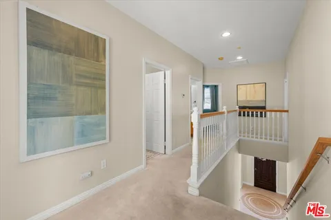 a spacious bedroom with a bed and glass window