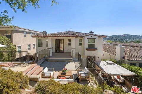 a spacious bedroom with a bed and glass window