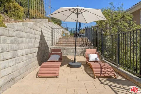 a view of a hallway with a livingroom and a bathroom with sink