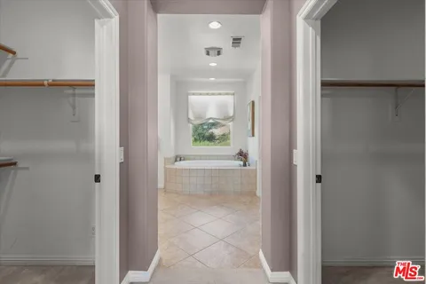 a bathroom with a granite countertop sink and a bathtub