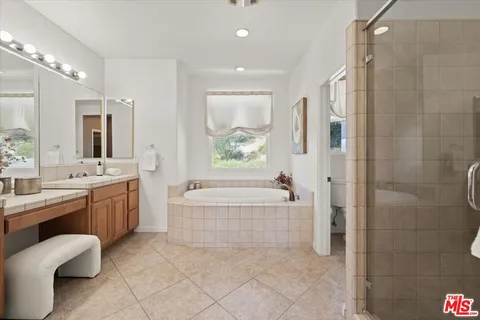 a bedroom with a bed and a refrigerator