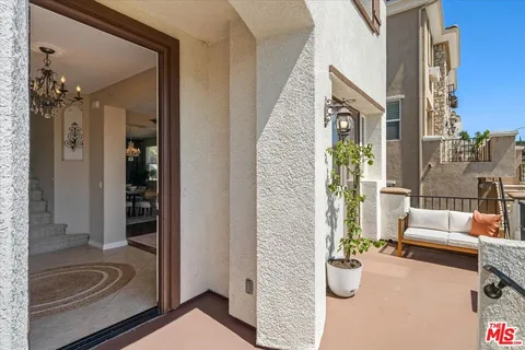 a living room with furniture a fireplace and a potted plant