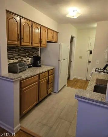 a kitchen with a refrigerator stove and sink