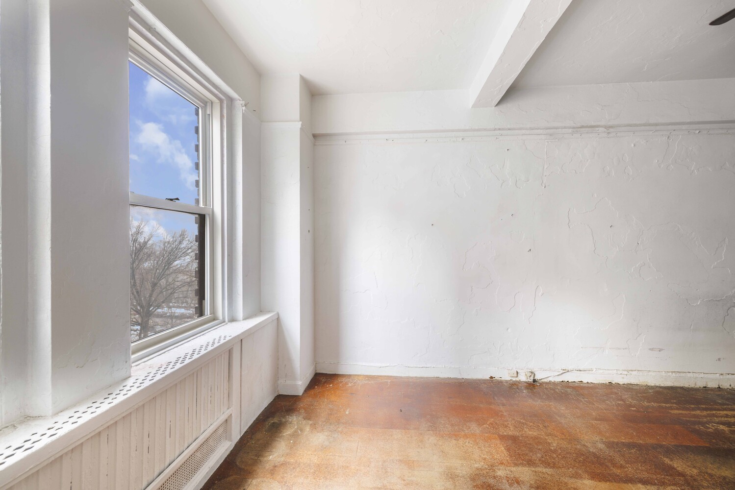 310 Riverside Drive, Unit 511 Manhattan, NY 10025 - Photo 6 of 11 a view of a small space with wooden floor and a window