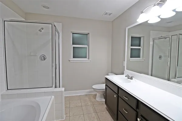 a bathroom with a double vanity sink mirror and toilet