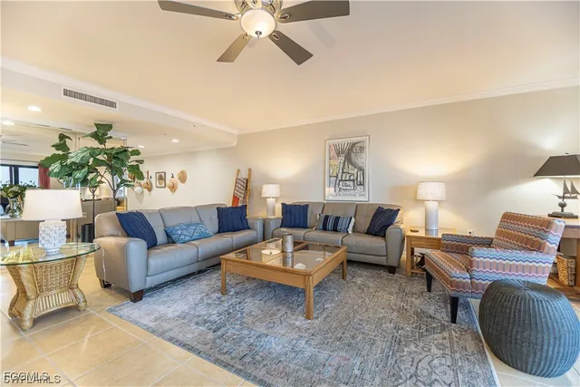 a living room with furniture a rug and a chandelier