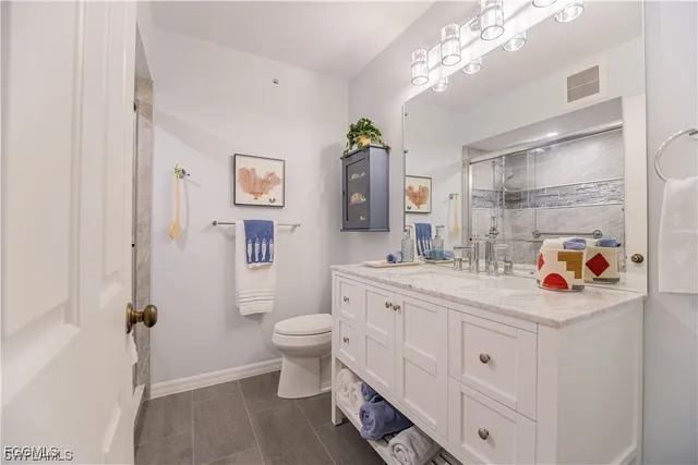 a bathroom with a sink toilet and a mirror