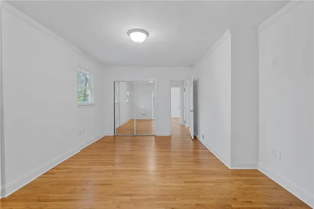 a view of an empty room with wooden floor