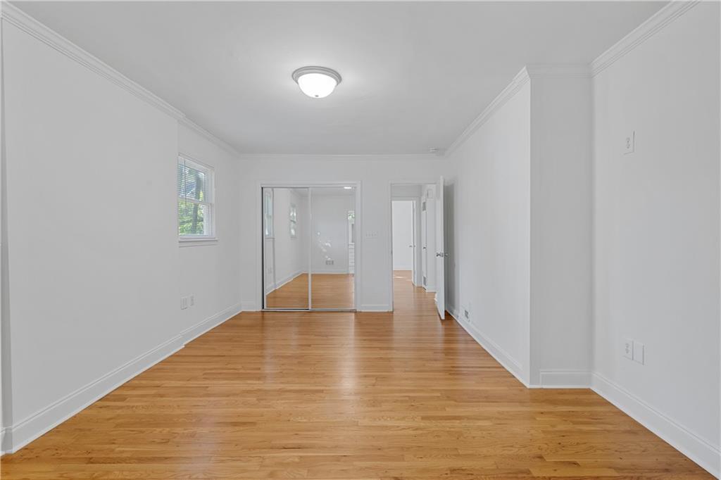 56 Mobile Avenue Northeast, Unit B Atlanta, GA 30305 - Photo 13 of 21 a view of an empty room with wooden floor