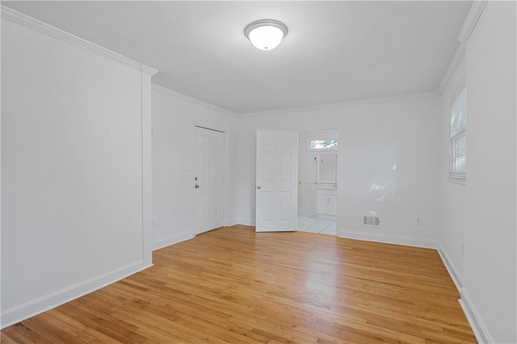 56 Mobile Avenue Northeast, Unit B Atlanta, GA 30305 - Photo 14 of 21 a view of an empty room with wooden floor