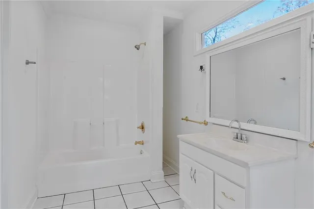 a bathroom with a sink a mirror and a bathtub