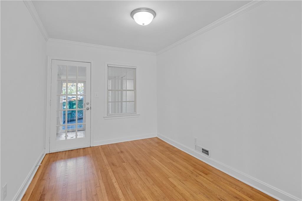 56 Mobile Avenue Northeast, Unit B Atlanta, GA 30305 - Photo 6 of 21 an empty room with wooden floor and windows