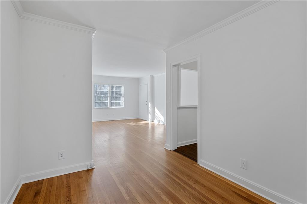 56 Mobile Avenue Northeast, Unit B Atlanta, GA 30305 - Photo 7 of 21 a view of an empty room with wooden floor and a window
