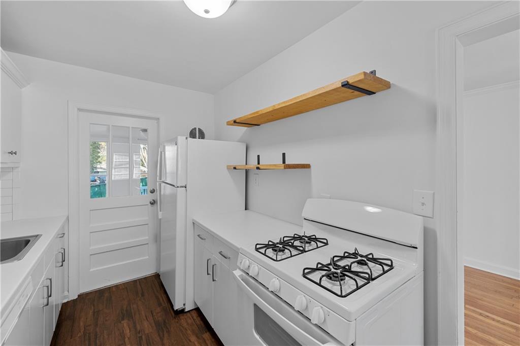 56 Mobile Avenue Northeast, Unit B Atlanta, GA 30305 - Photo 10 of 21 a kitchen with a refrigerator a stove and wooden floor