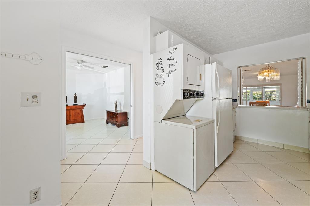 1271 Northwest 18th Avenue, Unit 5C Delray Beach, FL 33445 - Photo 11 of 36 a storage room with cabinets and washer