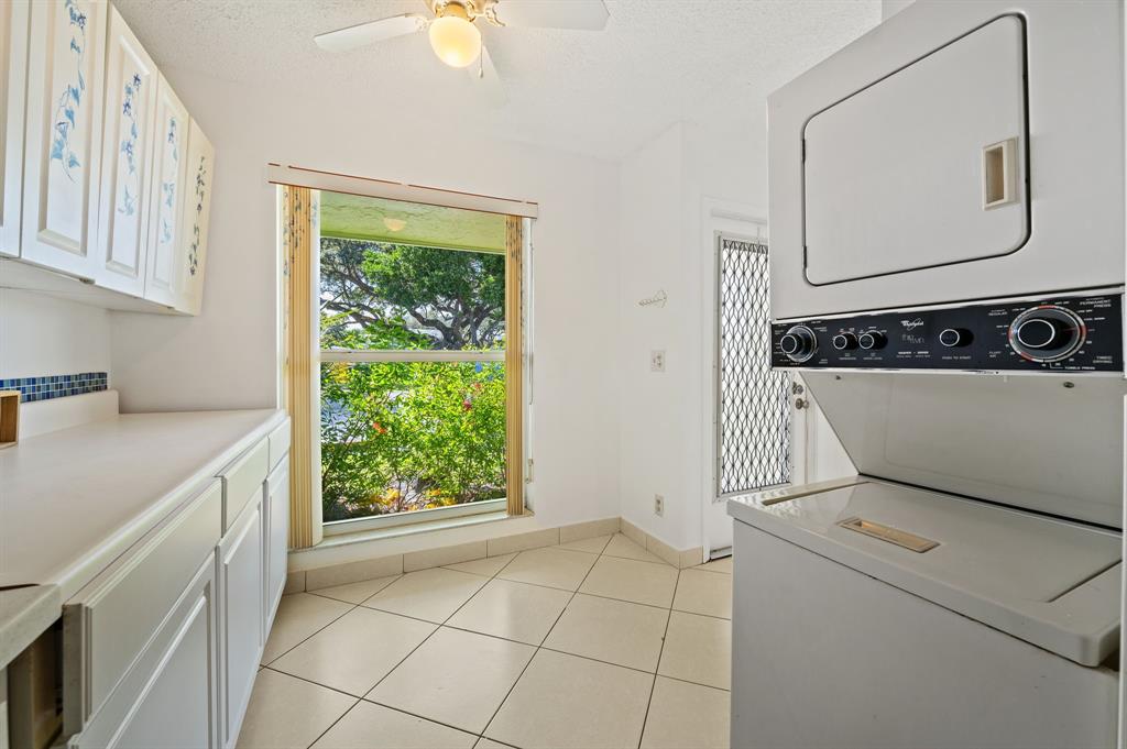 1271 Northwest 18th Avenue, Unit 5C Delray Beach, FL 33445 - Photo 13 of 36 a utility room with dryer and washer
