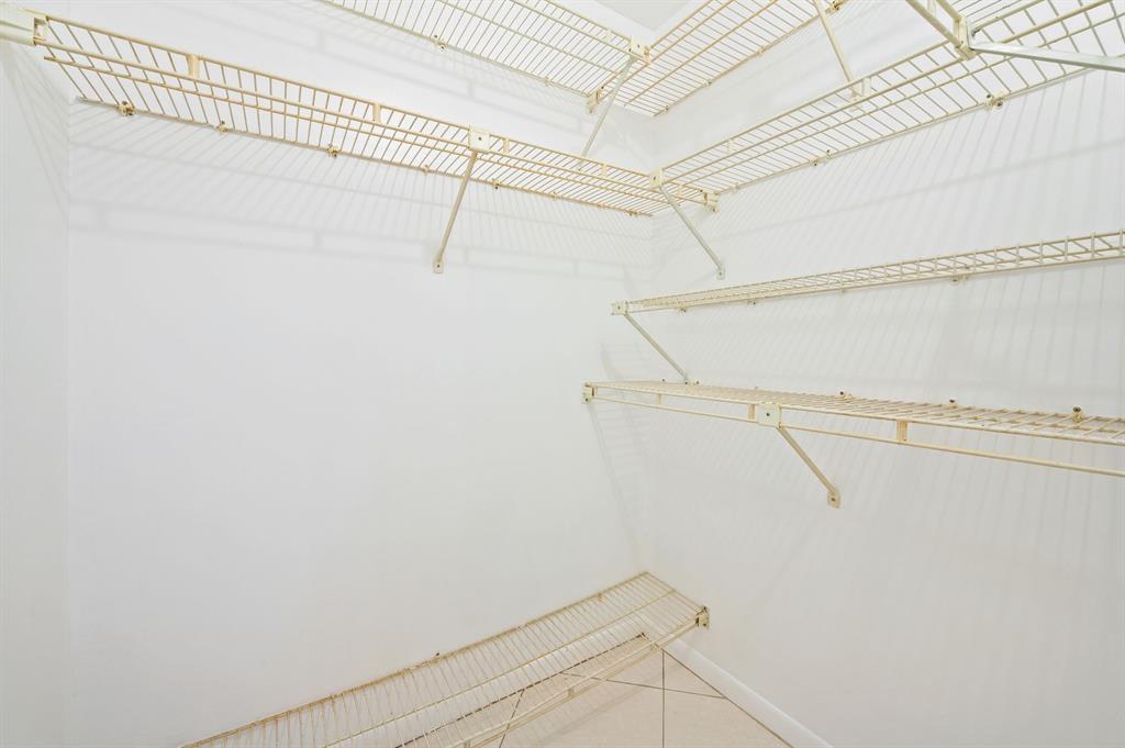 1271 Northwest 18th Avenue, Unit 5C Delray Beach, FL 33445 - Photo 16 of 36 a view of a room with racks on the wall