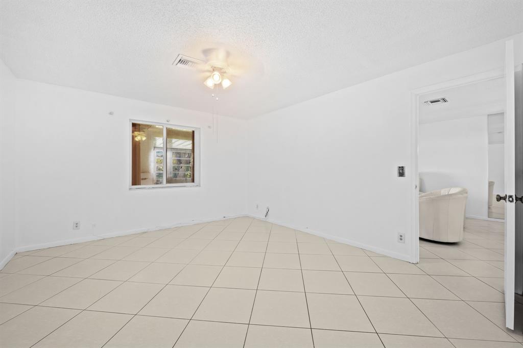 1271 Northwest 18th Avenue, Unit 5C Delray Beach, FL 33445 - Photo 19 of 36 a view of an empty room with a window