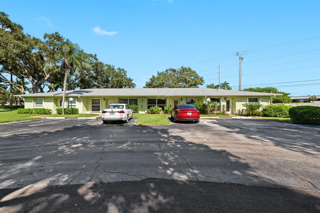 1271 Northwest 18th Avenue, Unit 5C Delray Beach, FL 33445 - Photo 2 of 36 a car parked in front of a house
