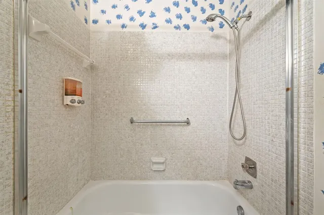 a bathroom with a glass shower door