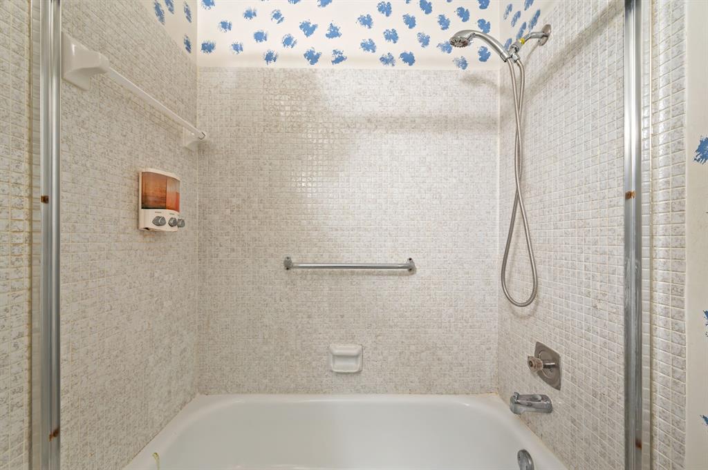 1271 Northwest 18th Avenue, Unit 5C Delray Beach, FL 33445 - Photo 21 of 36 a bathroom with a glass shower door