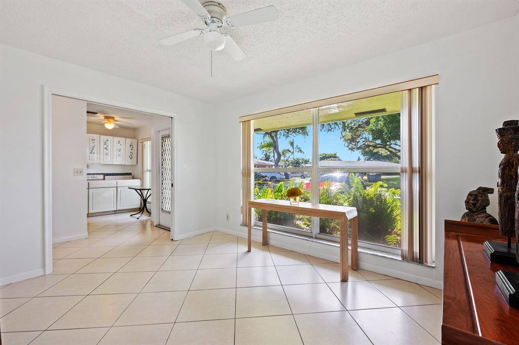 1271 Northwest 18th Avenue, Unit 5C Delray Beach, FL 33445 - Photo 23 of 36 a room with lots of furniture and a large window