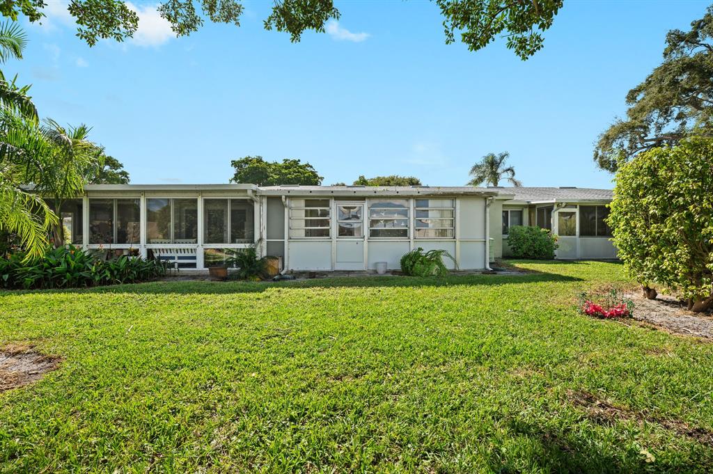 1271 Northwest 18th Avenue, Unit 5C Delray Beach, FL 33445 - Photo 26 of 36 a front view of a house with garden