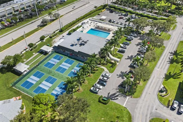 an aerial view of a house a yard and lake