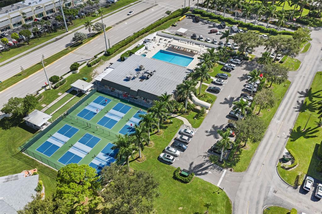 1271 Northwest 18th Avenue, Unit 5C Delray Beach, FL 33445 - Photo 32 of 36 an aerial view of a house a yard and lake