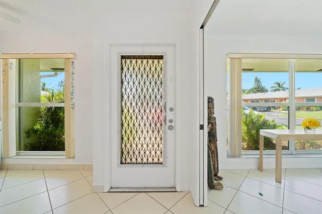 a view of an entryway with wooden floor and a rug