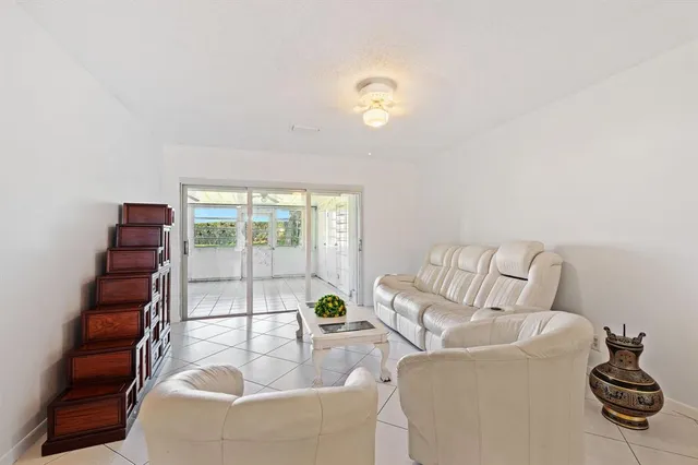 a living room with furniture and a floor to ceiling window