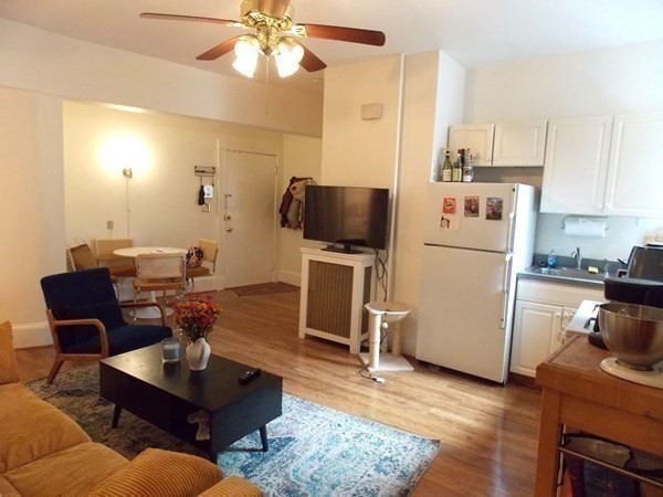 514 Harvard Street, Unit 2D Brookline, MA 02446 - Photo 1 of 11 a living room with furniture and a flat screen tv