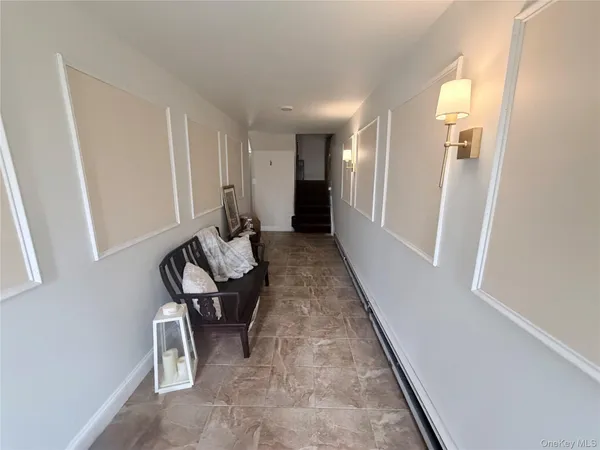 a hallway with chairs and a couch