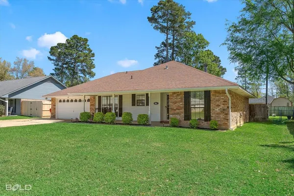 a view of a house with a yard and sitting area