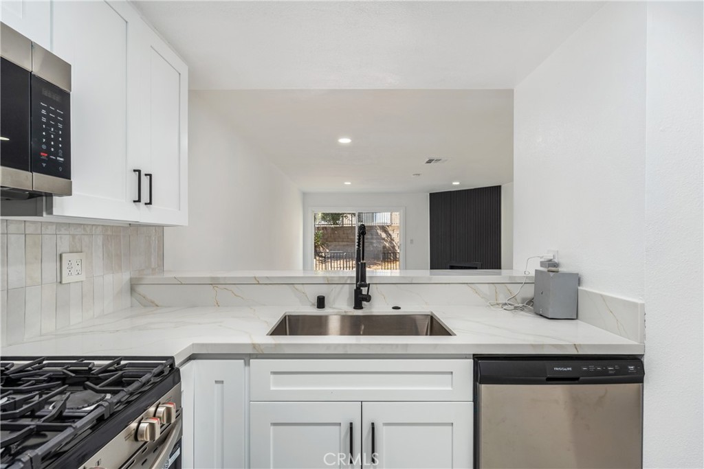 936 Fairway, Unit 8 Grand Terrace, CA 92324 - Photo 11 of 26 a kitchen with stainless steel appliances granite countertop a sink and cabinets