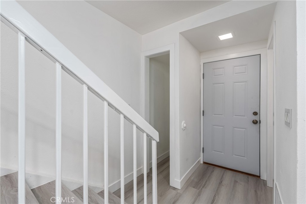 936 Fairway, Unit 8 Grand Terrace, CA 92324 - Photo 13 of 26 a view of a hallway with wooden floor and entryway