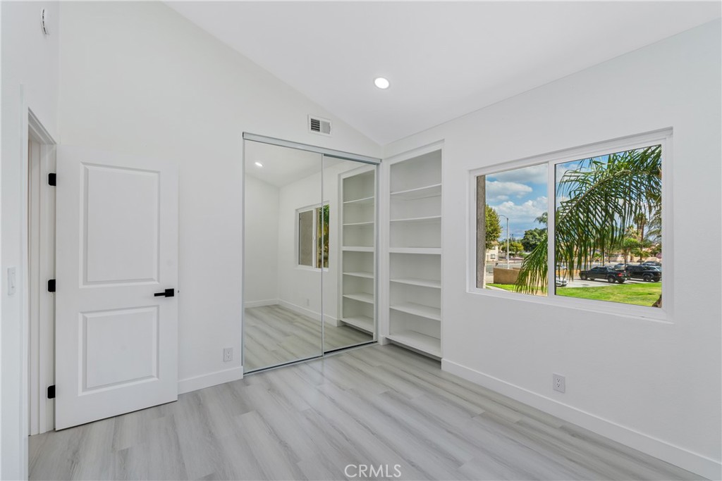 936 Fairway, Unit 8 Grand Terrace, CA 92324 - Photo 17 of 26 wooden floor in an empty room with a window