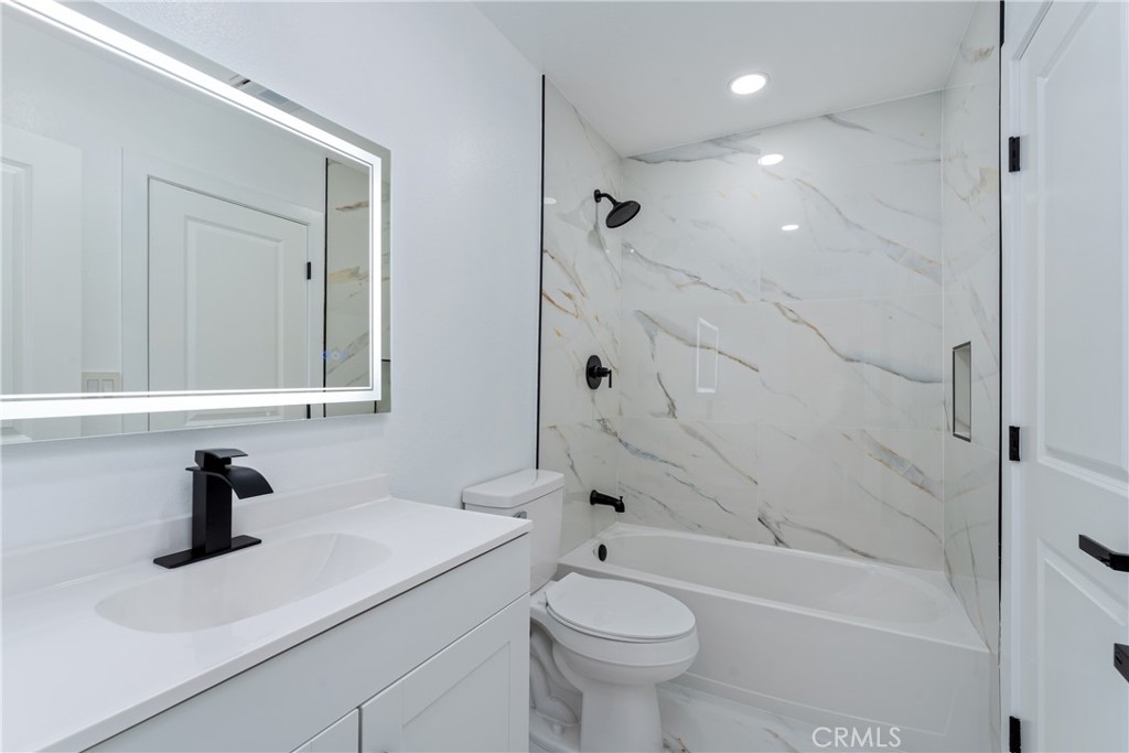 936 Fairway, Unit 8 Grand Terrace, CA 92324 - Photo 18 of 26 a bathroom with a sink a toilet and shower