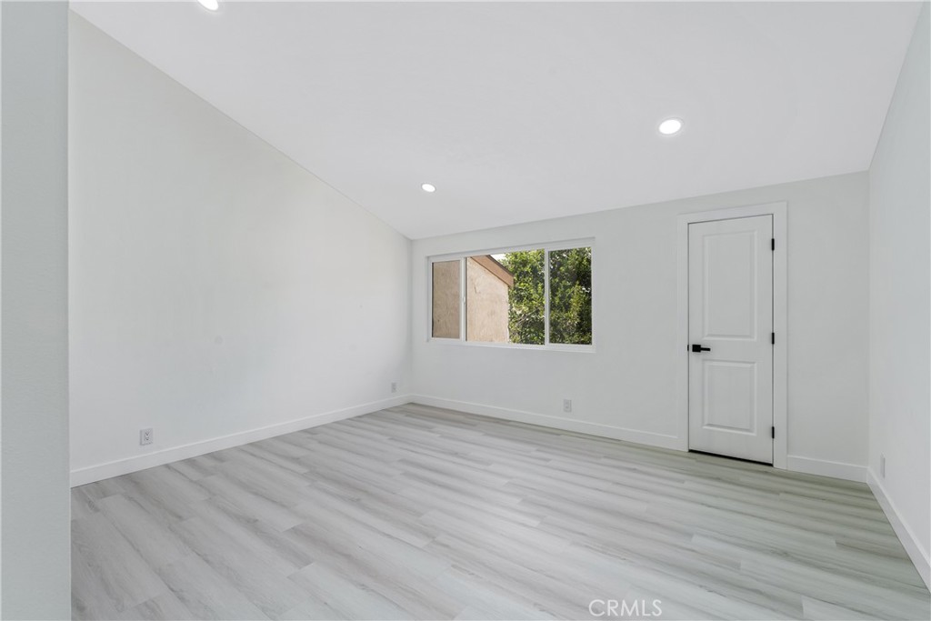 936 Fairway, Unit 8 Grand Terrace, CA 92324 - Photo 19 of 26 a view of an empty room with wooden floor and a window