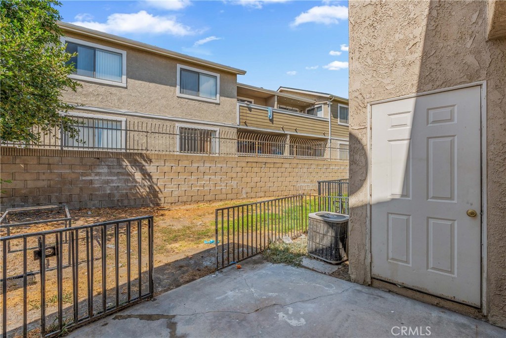 936 Fairway, Unit 8 Grand Terrace, CA 92324 - Photo 24 of 26 a view of a house with a wooden fence