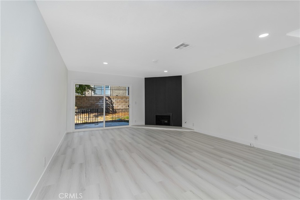 936 Fairway, Unit 8 Grand Terrace, CA 92324 - Photo 6 of 26 a view of an empty room with wooden floor