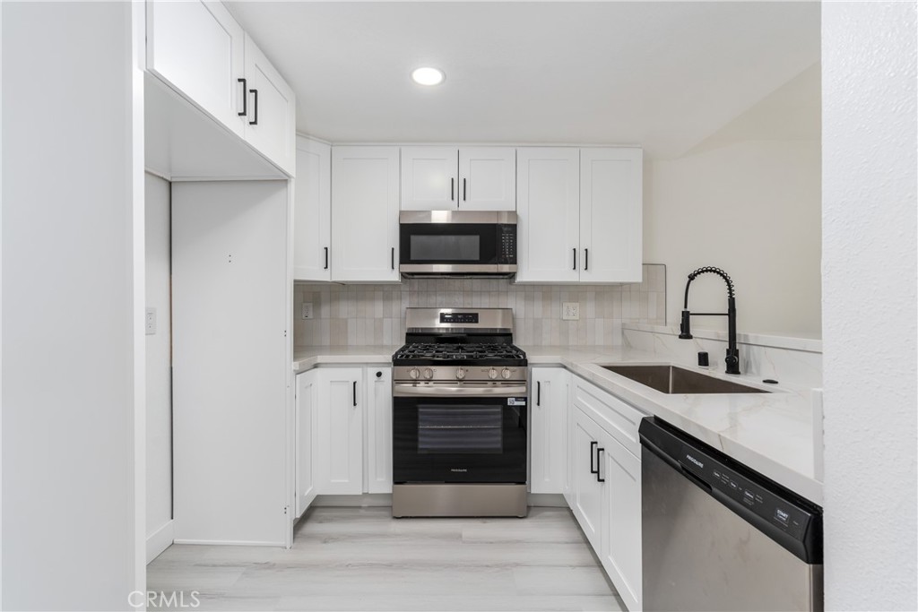 936 Fairway, Unit 8 Grand Terrace, CA 92324 - Photo 9 of 26 a kitchen with a stove and a sink