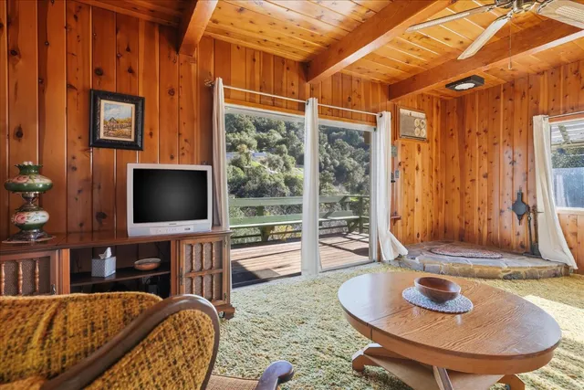 a view of a porch with a table and chairs
